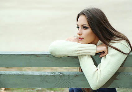 woman sitting on a bench reflecting on her counseling and link to the individual therapy page