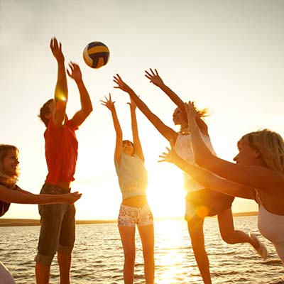 Teens playing volleyball