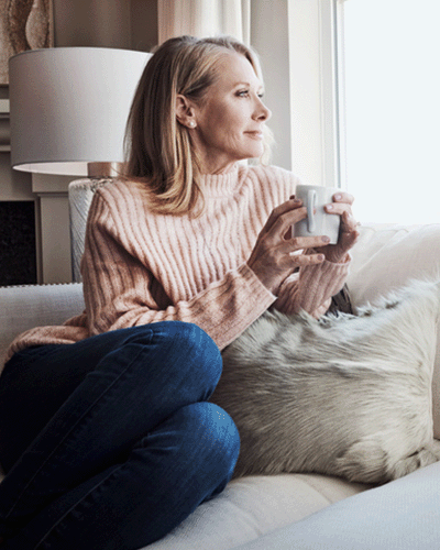 Woman holding coffee cup in deep thought about her therapy session at Jupiter Community Counseling